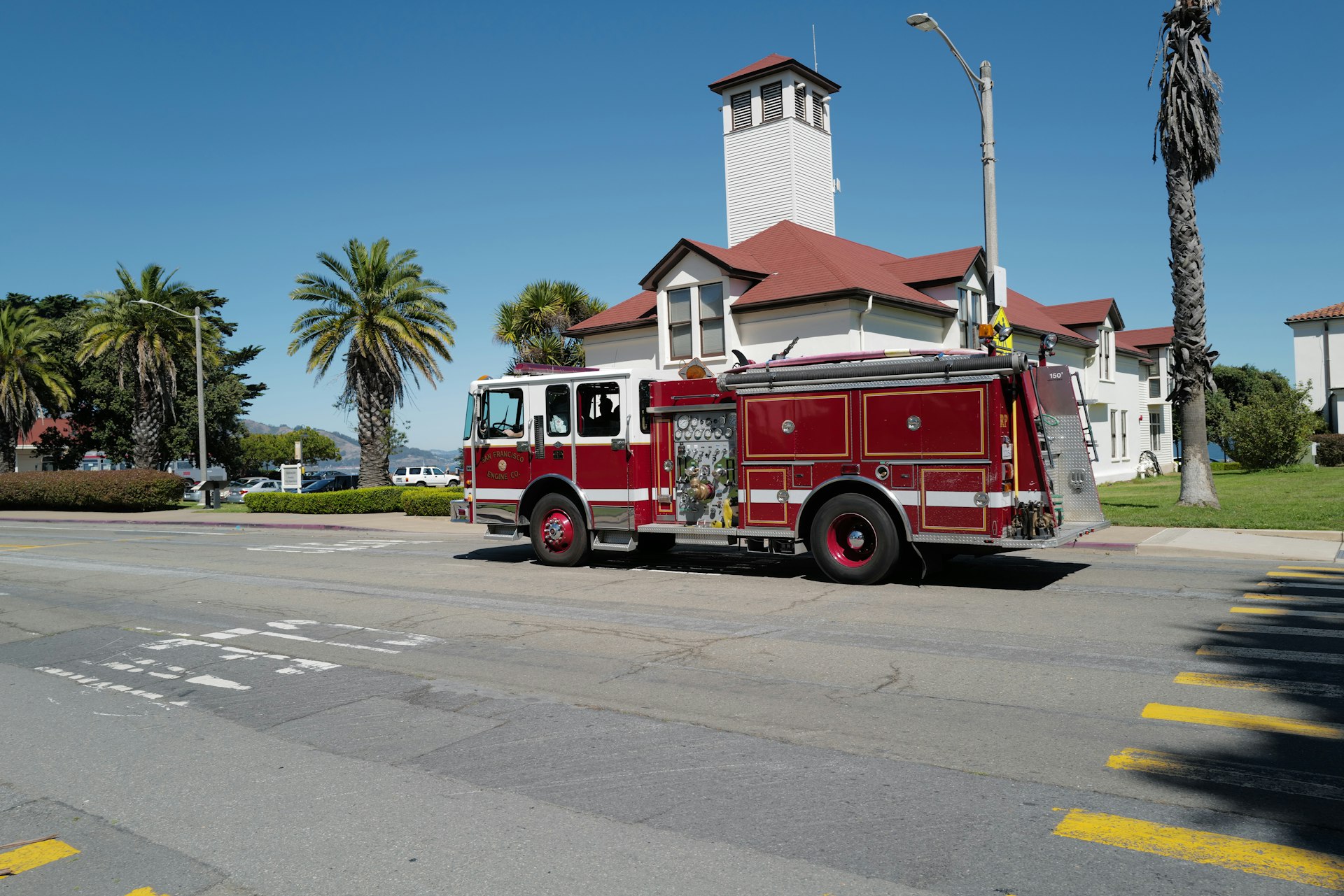 Red fire truck parked in front of a church